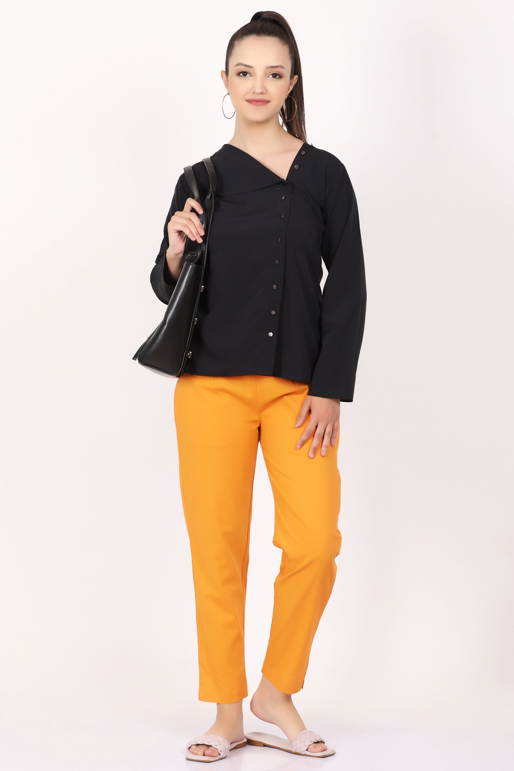 a man wearing a yellow shirt and black pants Stock Photo by Icons8